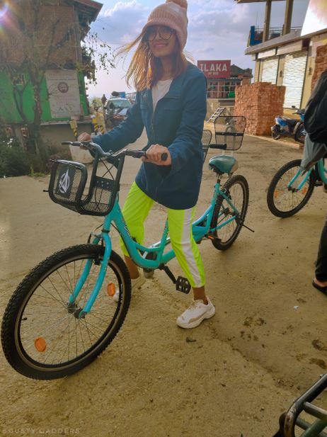 A girl on bicycle in neon pants