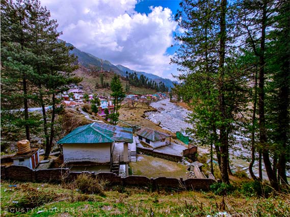 small colorful huts in valley with Uhl river beneath and mountains in the backdrop